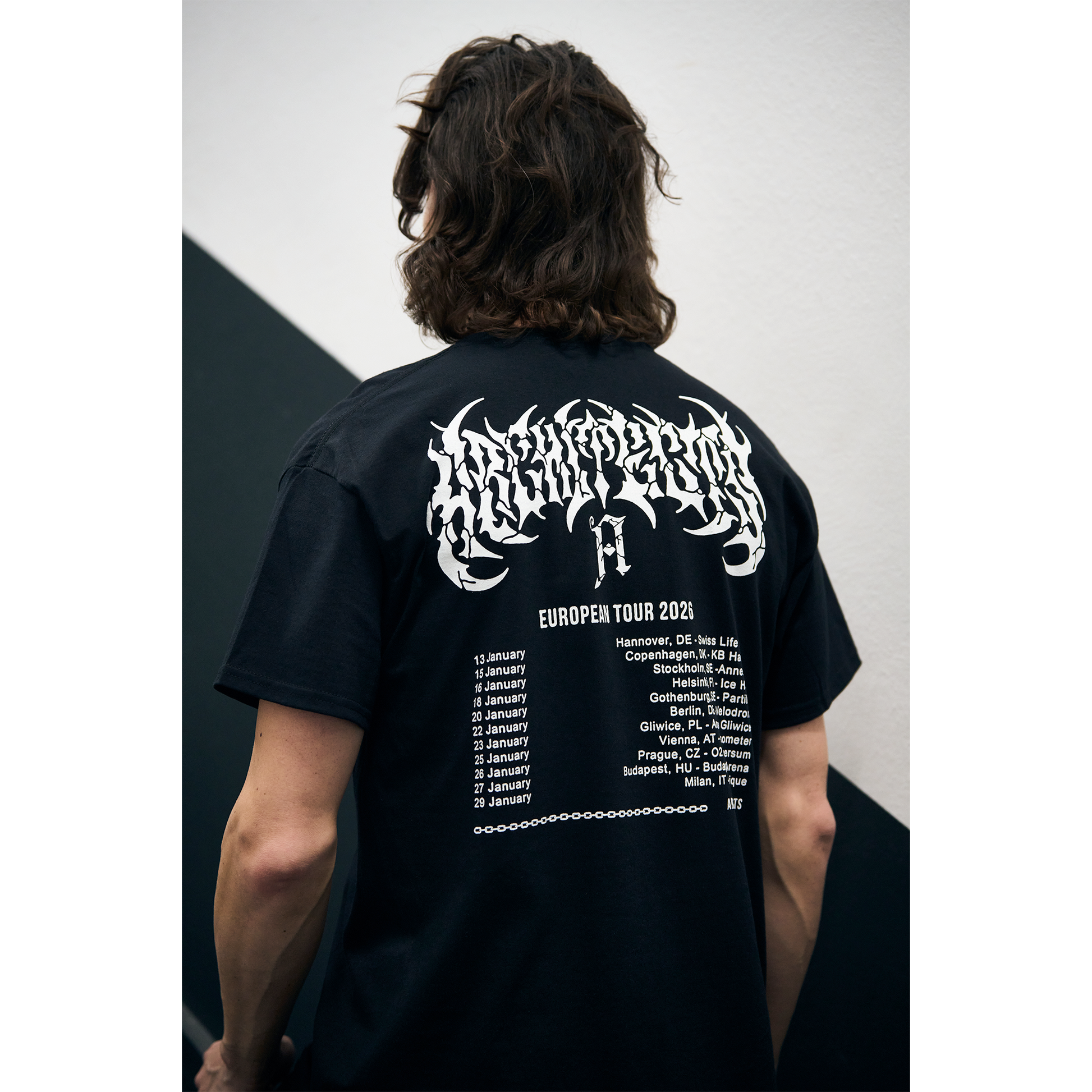 Man wearing a black short-sleeve t-Shirt with Architects European 2026 Tour dates printed across the back
